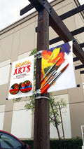 Double-sided street pole banners mounted on a lamp post