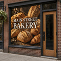 Full-color one-way perforated window graphic covering a bakery storefront window, seen from outside