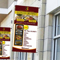 Wall-mounted vertical banners on a storefront